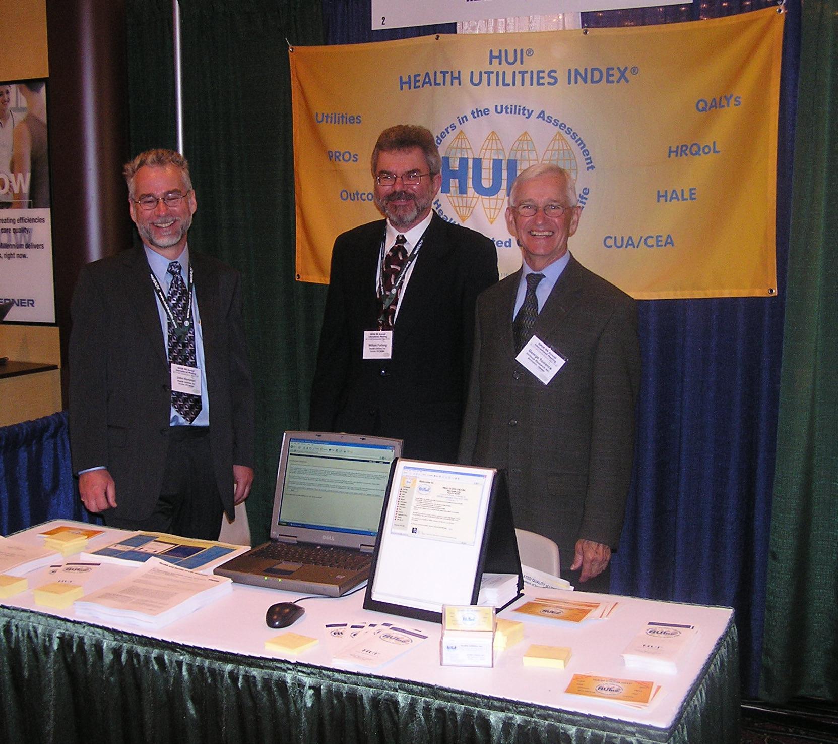 L to R - John Horsman, Bill Furlong, George Torrance at the HUInc Booth, International Society for Pharmacoeconomics and Outcomes Research - ISPOR, May 2003, Arlington, VA, USA.